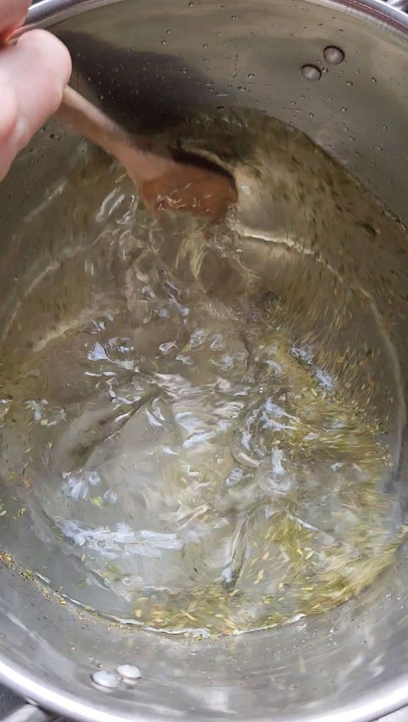 Stirring seasonings to the water in a stock pot for crab boil.