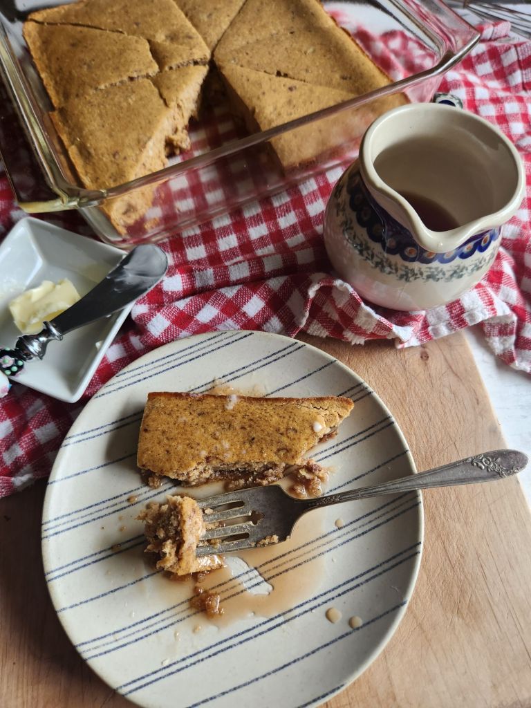 Easy gluten-free fluffy baked pecan pancake on a plate with syrup.