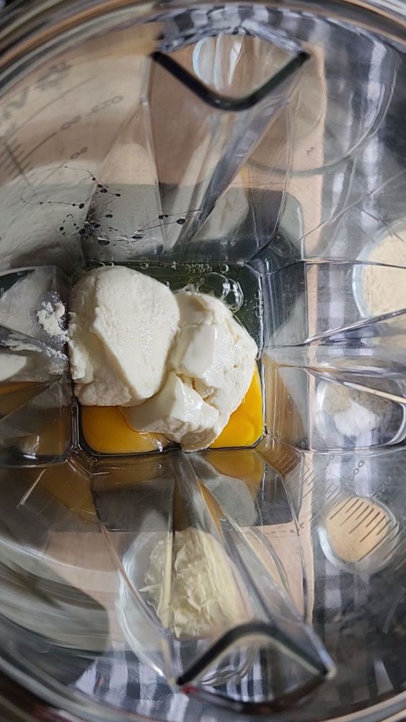 Cream cheese and eggs in blender to make easy gluten-free keto mini pizza chaffles recipe.