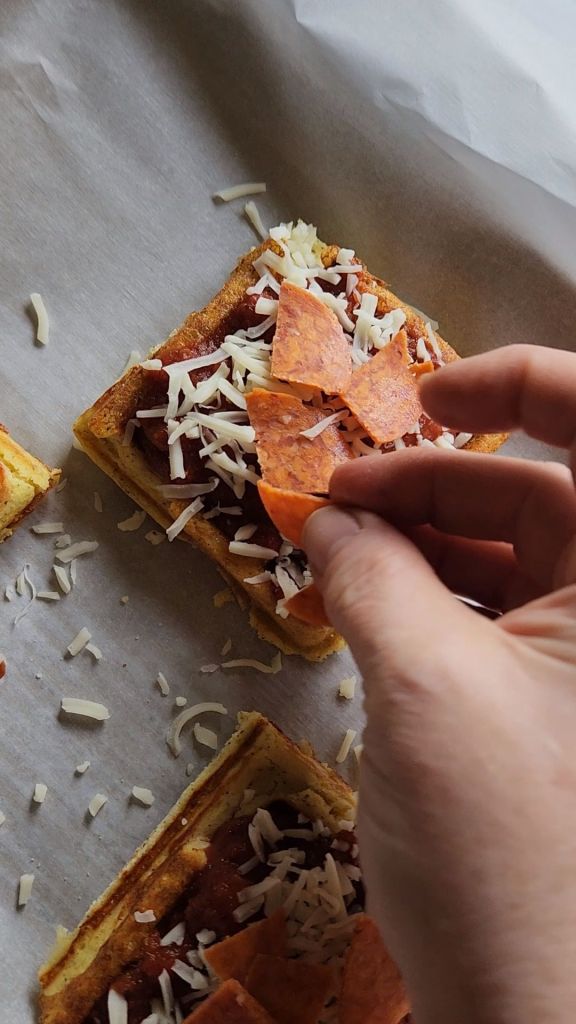 Topping easy gluten free keto mini pizza chaffles with pepperoni and cheese