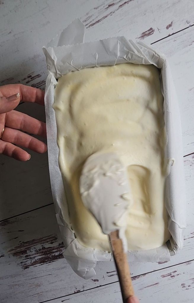 Spreading batter for gluten-free flourless Hawaiian keto bread in a parchment lined pan.