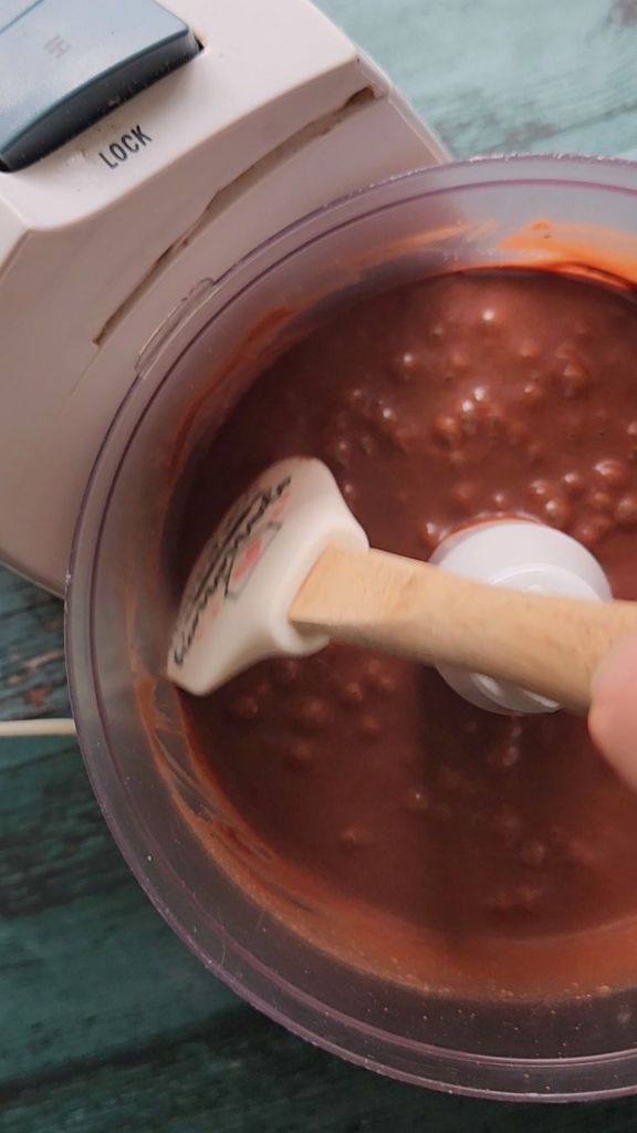 Scraping the sides of the Bowl before continuing to mix the gluten-free Bailey's Irish cream chocolate bundt cake.