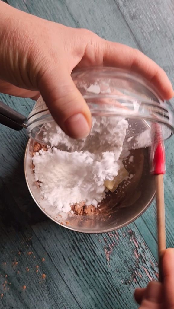 Heading on ingredients to saucepan to make sugar-free chocolate glaze.