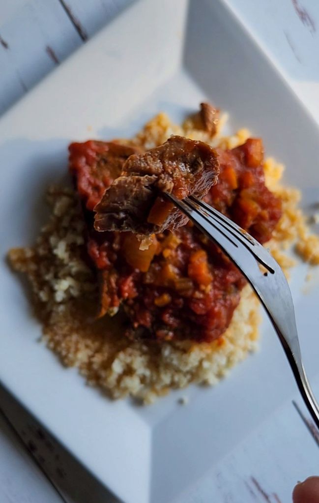 Close up of a bite of easy gluten-free copycat McCormick's Swiss steak.