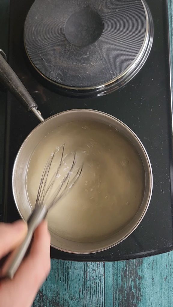 Stirring ingredients in saucepan for easy low carb Starbucks Copycat vanilla syrup recipe.