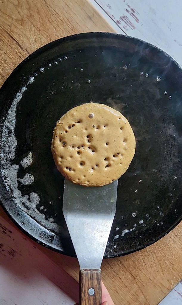 Flipping cooked pancake on griddle from easy gluten.Free blunder pancake recipe dairy free.