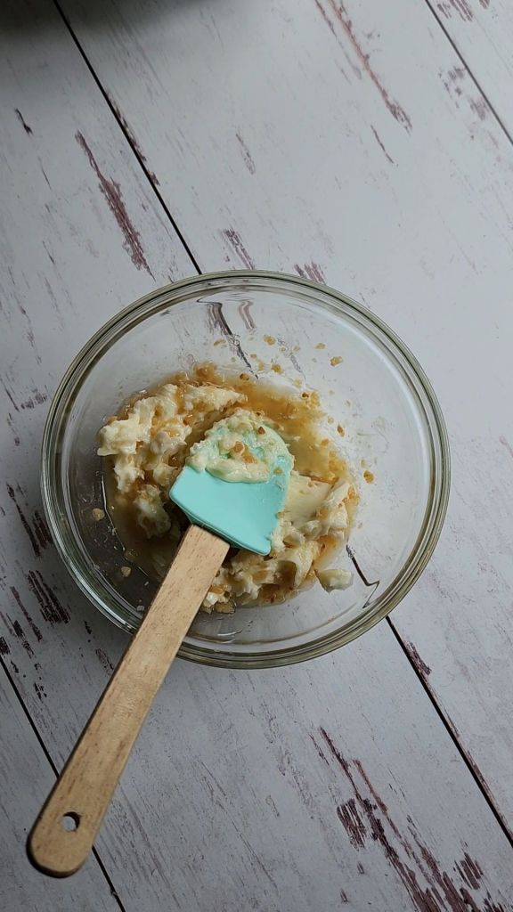 Blending Lemon garlic butter compound to make gluten-free baked.Almond crusted with lemon garlic halibut.