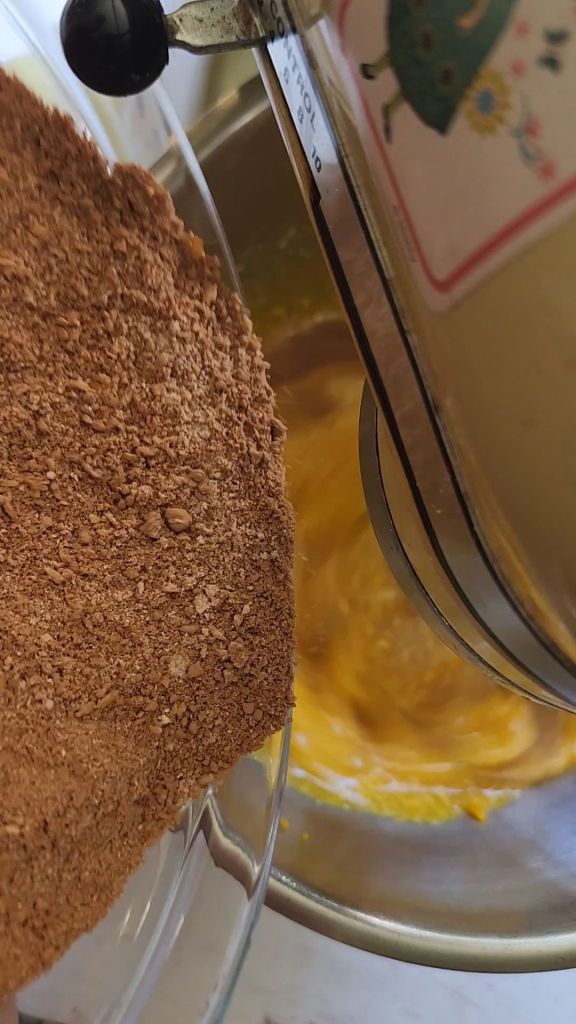 Adding dry ingredients to the wet ingredients for The best dairy free low carb chocolate cake recipe.
