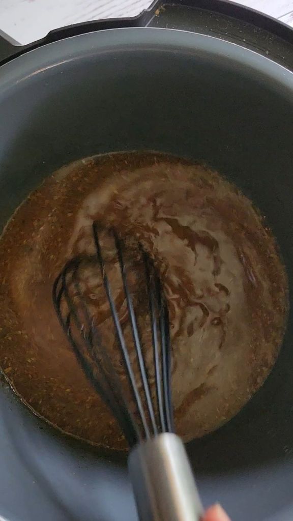 Deglazing the instapot pan with broth Easy instant pot carnitas from a pork shoulder roast.
