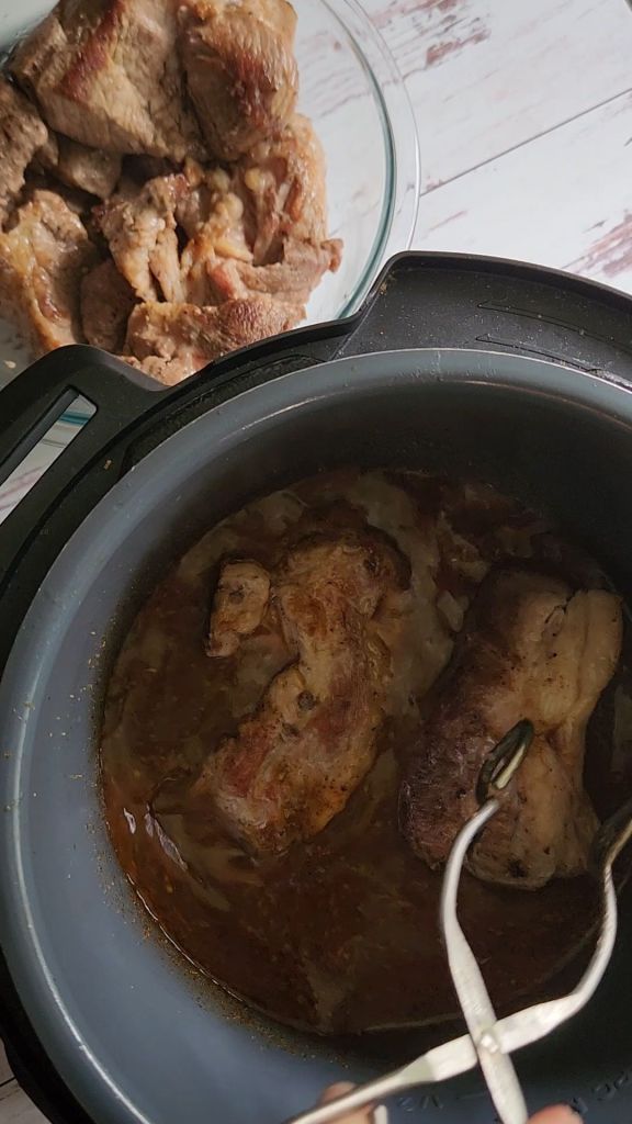 Putting seared pork back into instant pot for Easy instant pot carnitas from a pork shoulder roast.