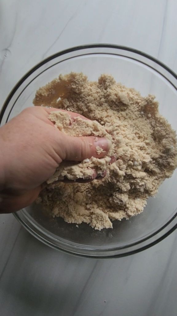 Is breaking up dry ingredients for Gluten Free Keto Mini Glazed Donut Muffins Recipe.