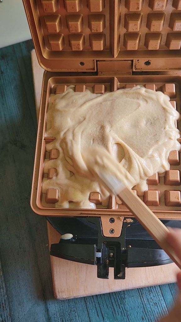 Pouring Easy gluten free low carb breakfast chaffle waffles batter into waffle maker.