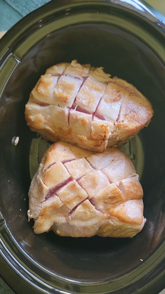 Placing seared pork loin roast into slow cooker
