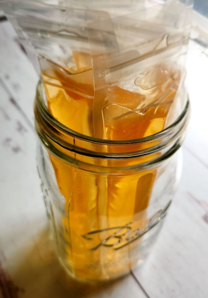 Push pop containers filled with gel mixture being held upright in a wide mouth quart jar.