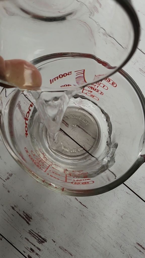 pouring water into measuring Cup.