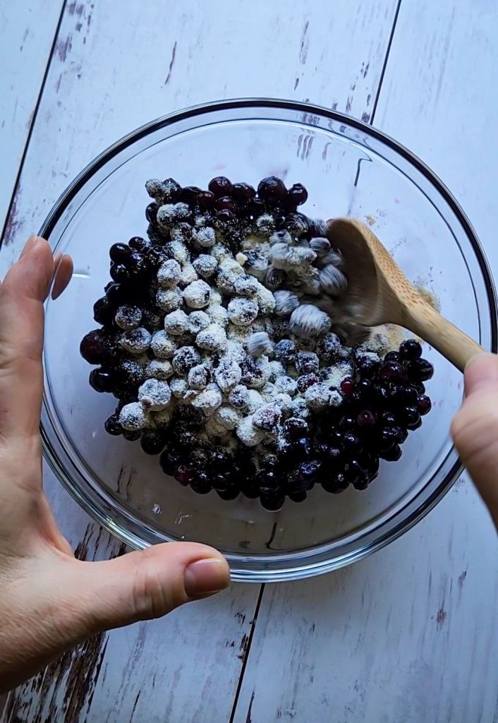 Stirring coconut flour into berries.