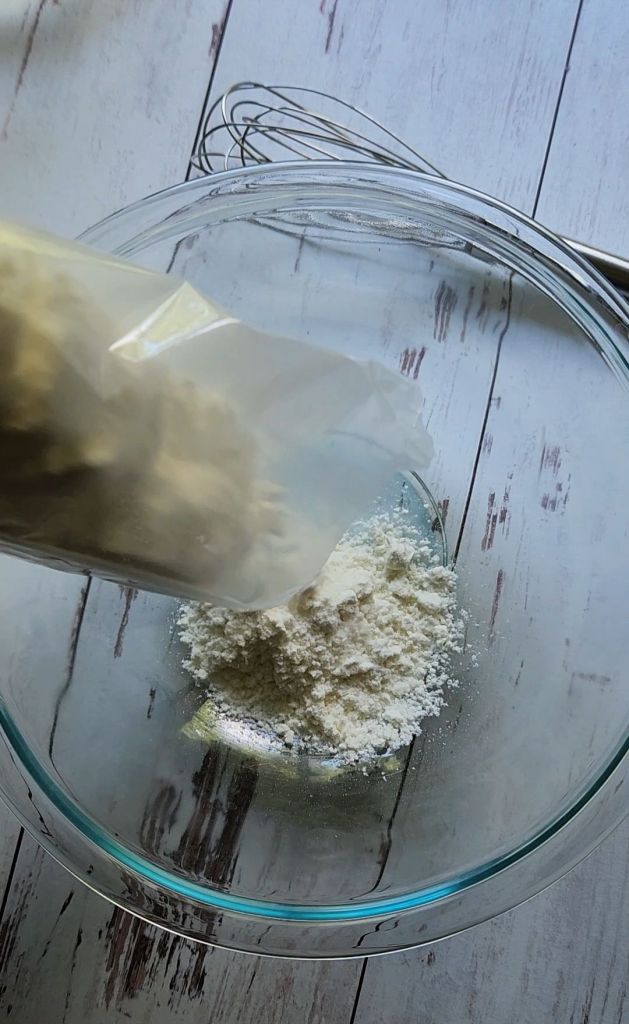 Pouring cake mix into large bowl.