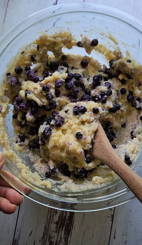 Folding blueberries into batter for Quick Gluten Free Blueberry Muffins with a Cake Mix.