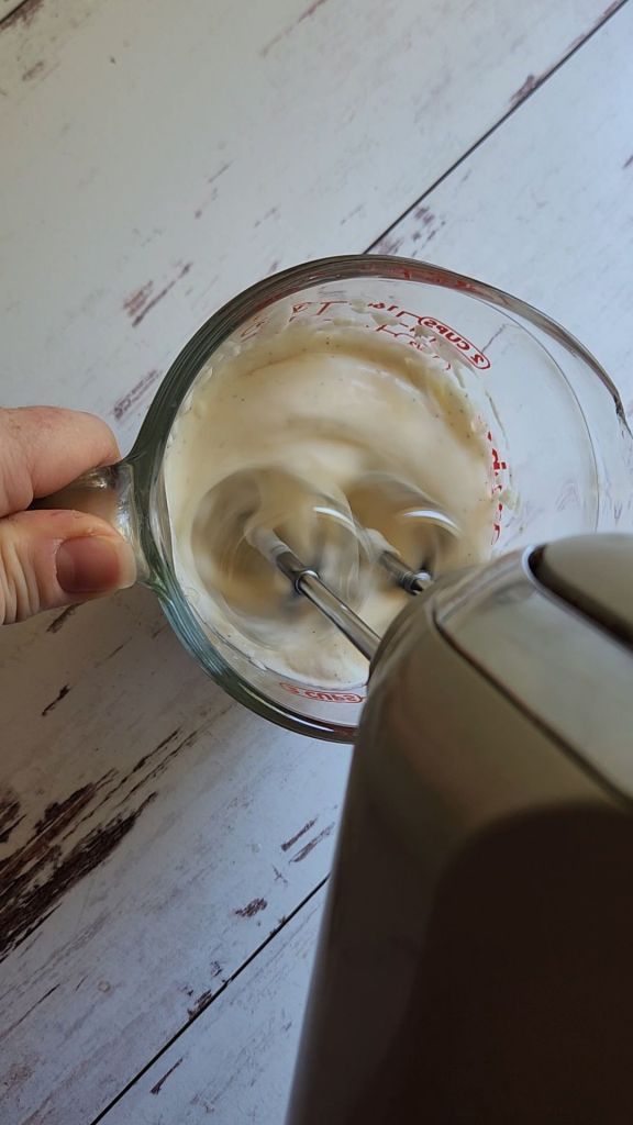 Whipping jel with whipped cream for easy keto jello creamsicle parfait dessert recipe.