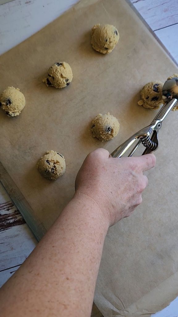 Scooping batter onto pan for Soft batch Gluten Free low carb chocolate chip cookie.