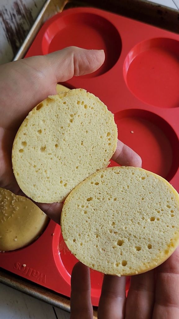 The best ever gluten free soft hamburger buns being split in half.