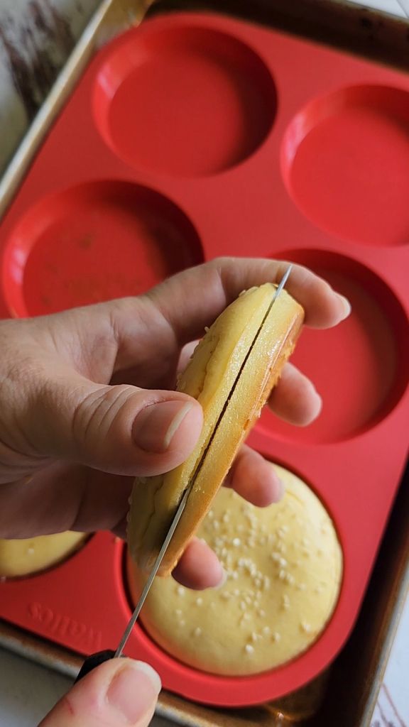 The best ever gluten free soft hamburger buns being split in half.