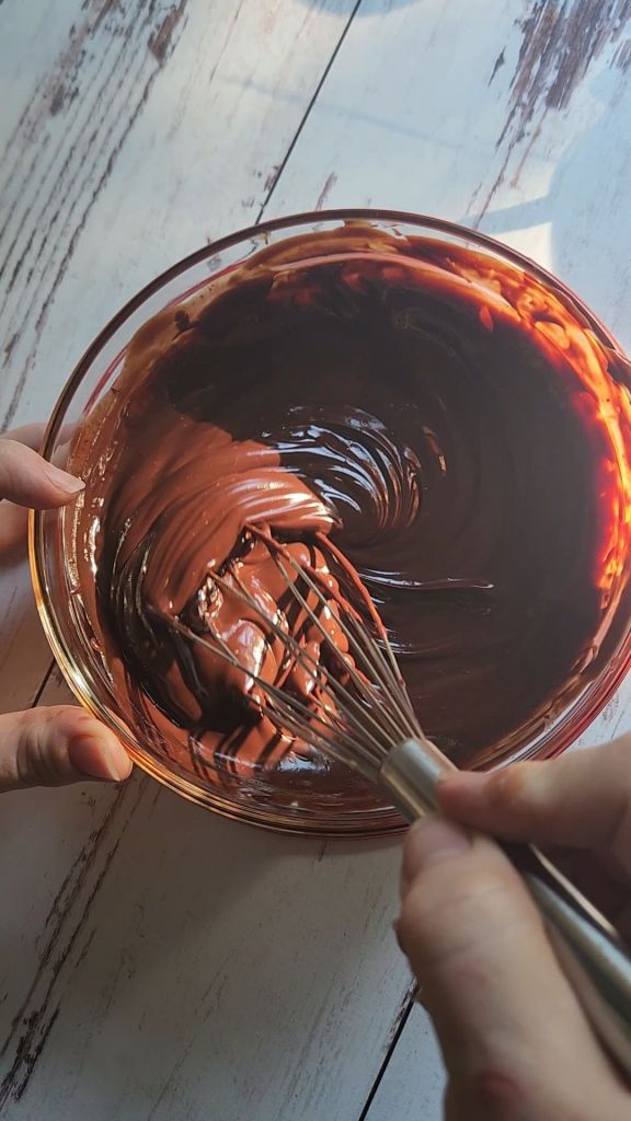 Whisking ganache topping.