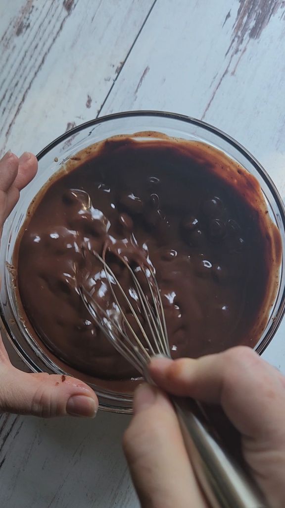 Whisking ganache topping.