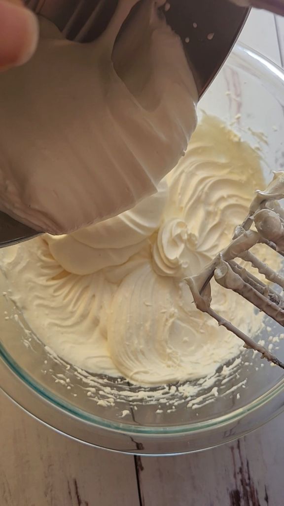 Combining whipped cream mixture with cream cheese mixture for 5 ingredient No bake gluten free cheese cake recipe.