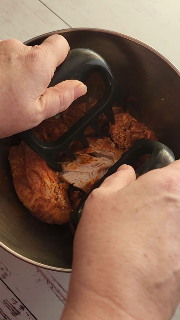 Shredding chicken for Easy instapot gluten free mexican casserole recipe.