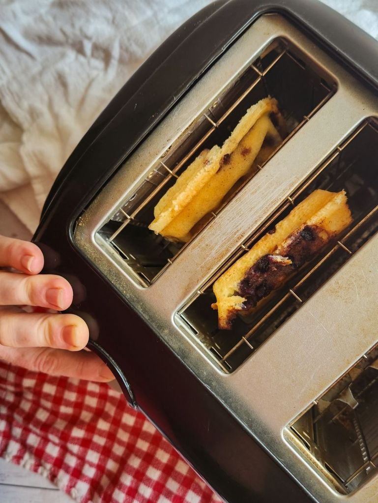 Reheating Easy Gluten-Free Dairy-Free Blueberry Waffles in toaster.