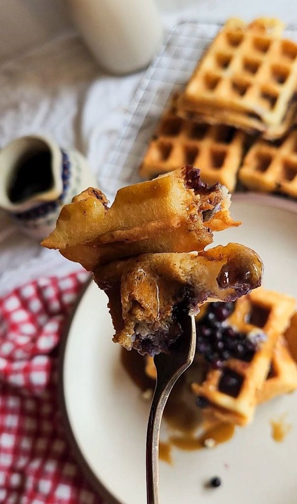 Close up bite of Easy Gluten-Free Dairy-Free Blueberry Waffles Recipe.