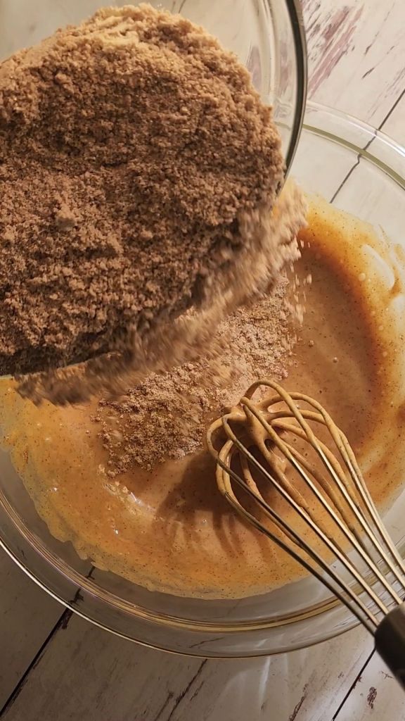 Mixing dry ingredients into wet ingredients for Easy gluten free zucchini bread with yellow squash recipe.