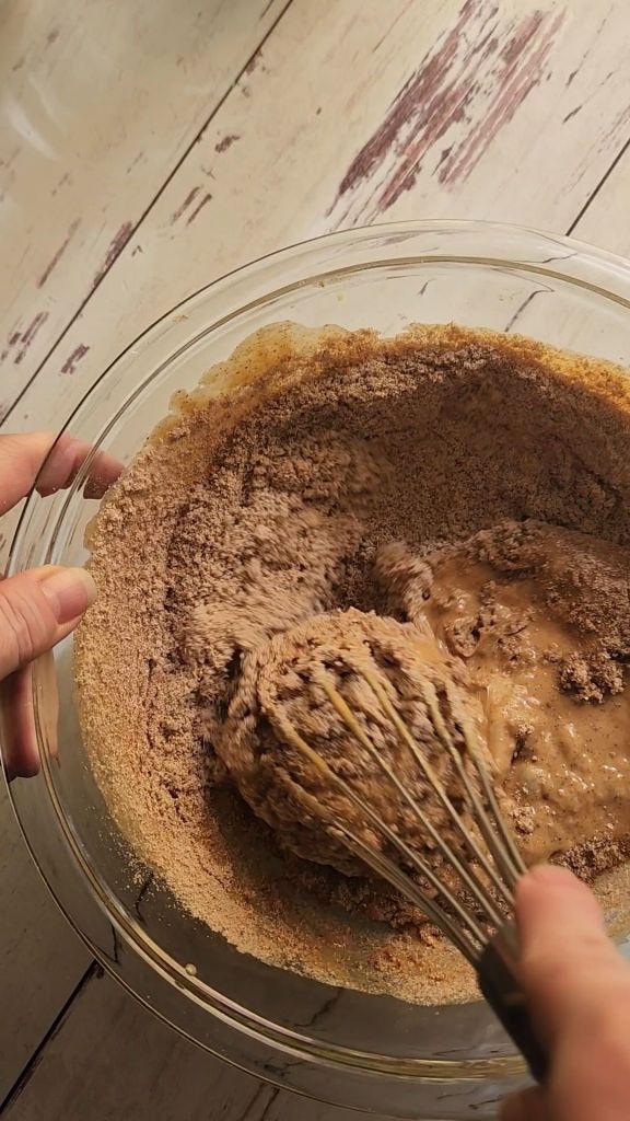 Mixing dry ingredients into wet ingredients for Easy gluten free zucchini bread with yellow squash recipe.