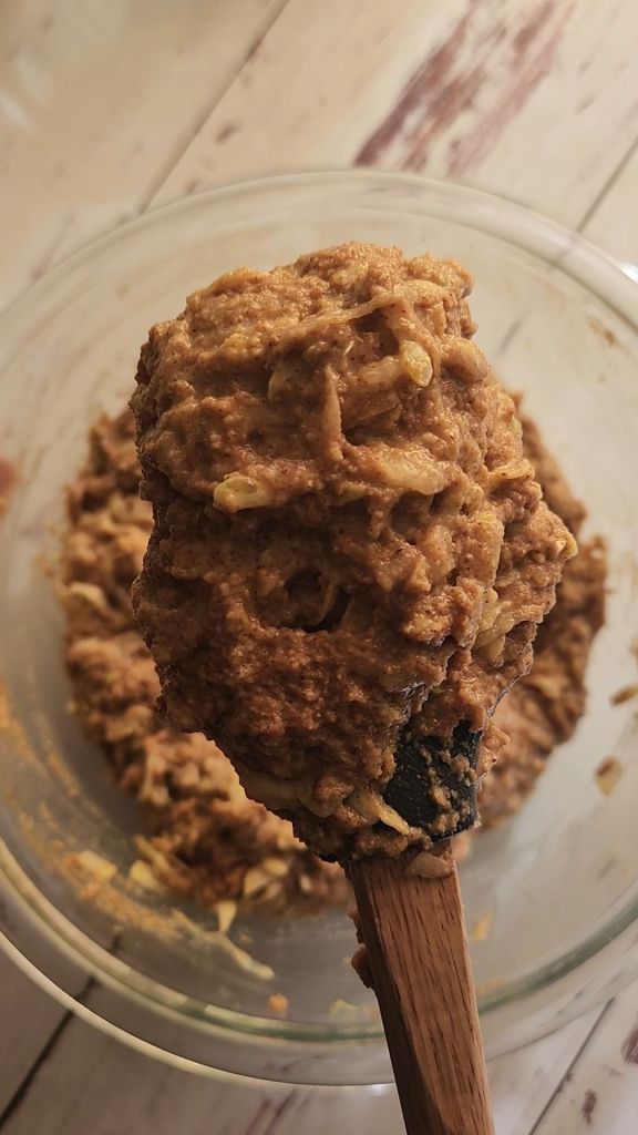 Folding shredded yellow squash into batter for Easy gluten free zucchini bread with yellow squash recipe.