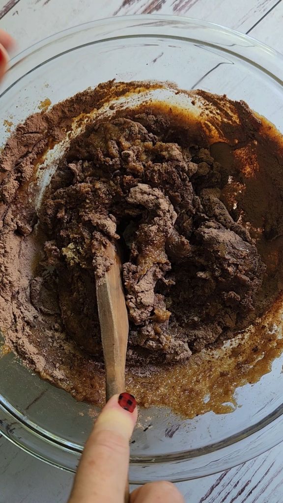 Stirring protein powder into Gluten free keto almond butter protein cookies batter.