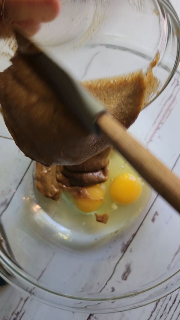 Adding nut butter to bowl with eggs.