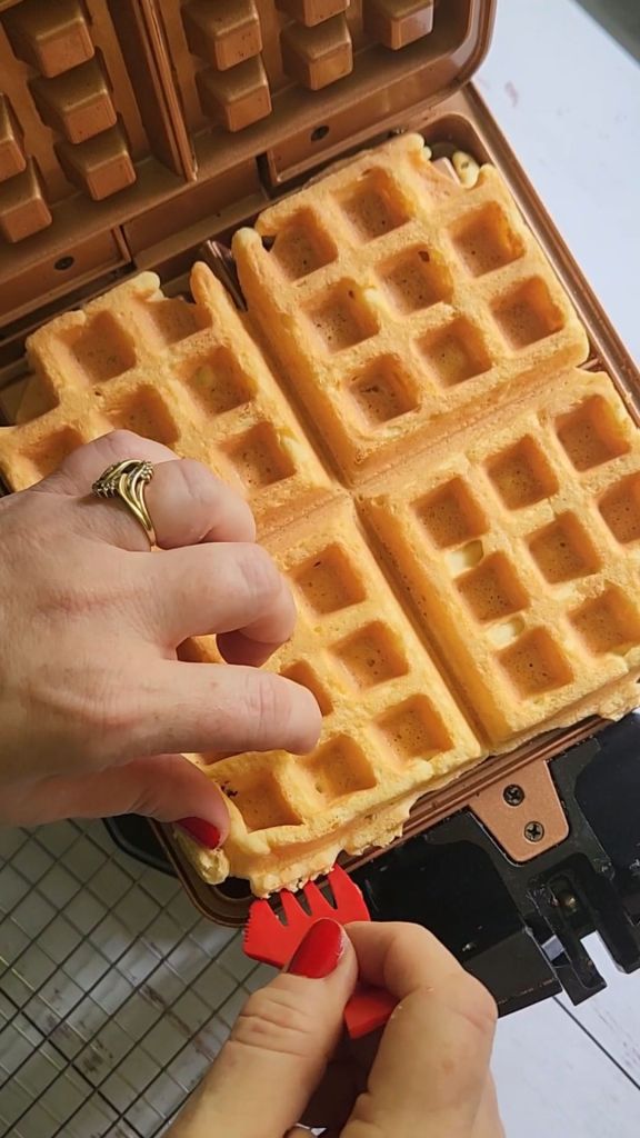Pulling out Easy gluten free protein waffles just made in wafflemaker.