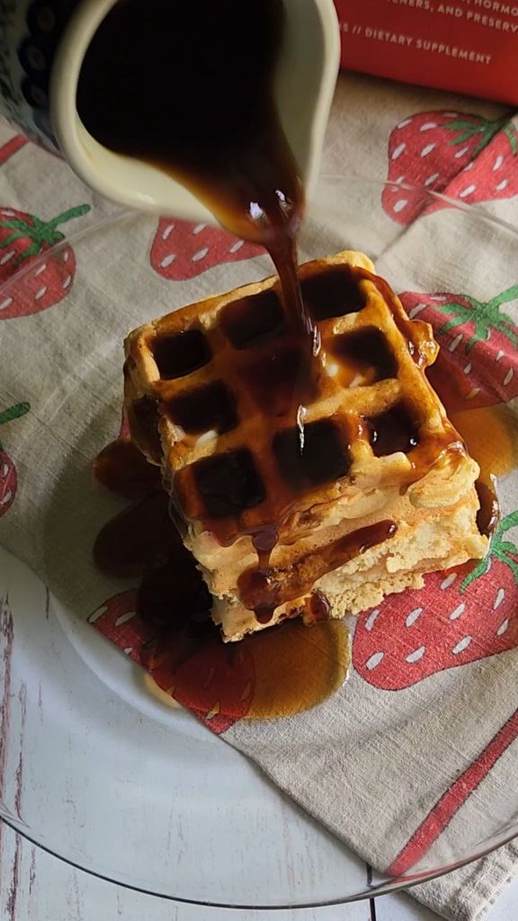 Pouring syrup on Easy gluten free protein waffle recipe without milk.