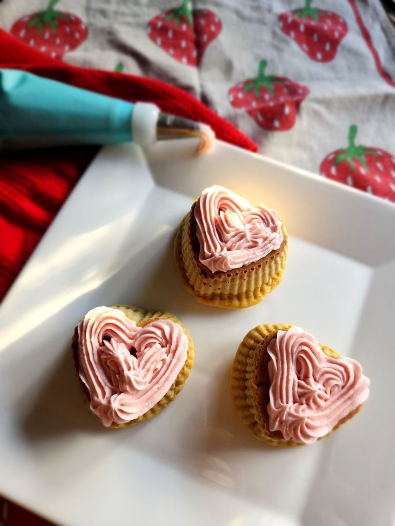 Heart cupcakes frosted with gluten , free strawberry pudding frosting.