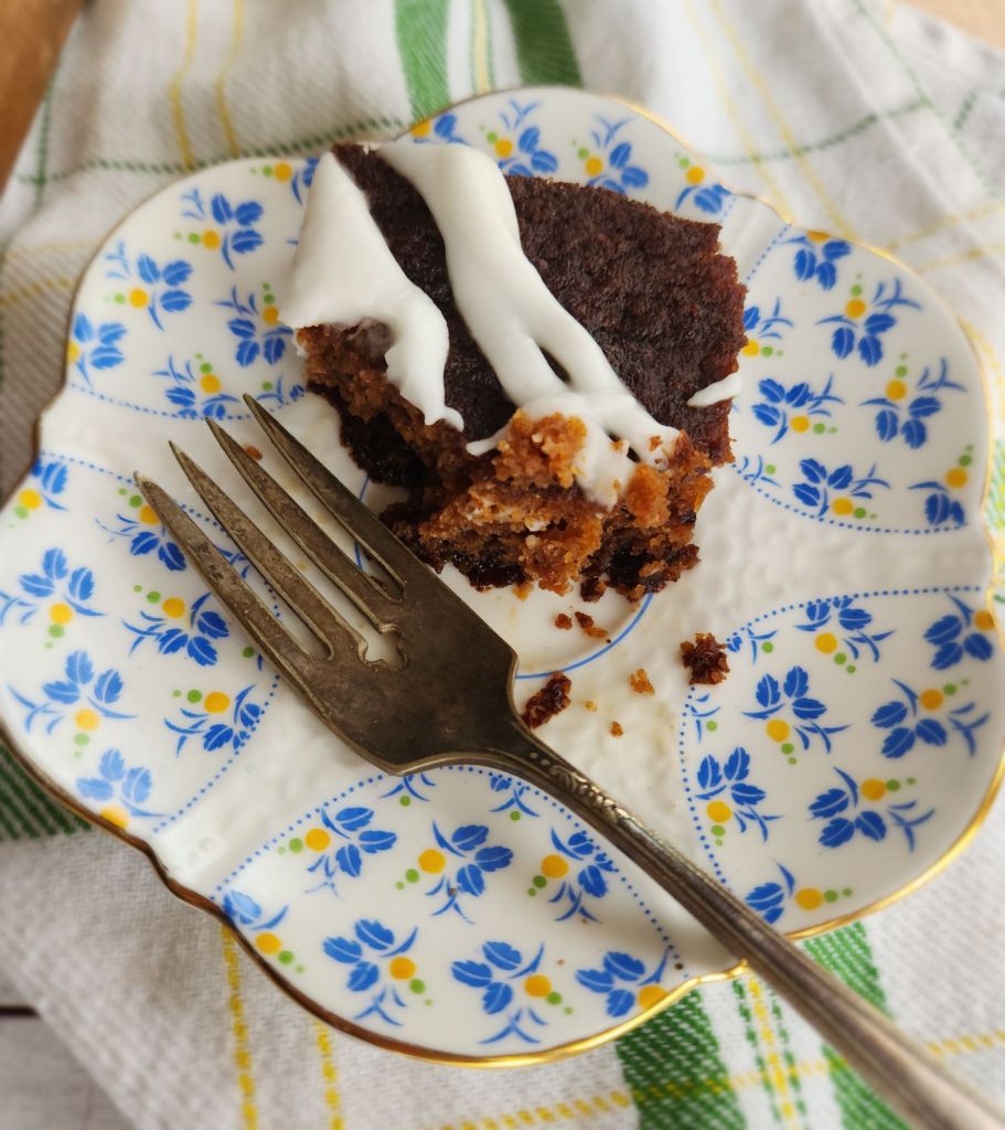 A plate with a piece of gluten free irish spice cake with a fork