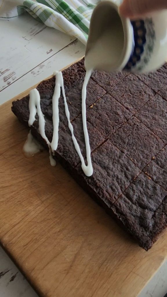Drizzling glaze on easy gluten , free irish spice cake