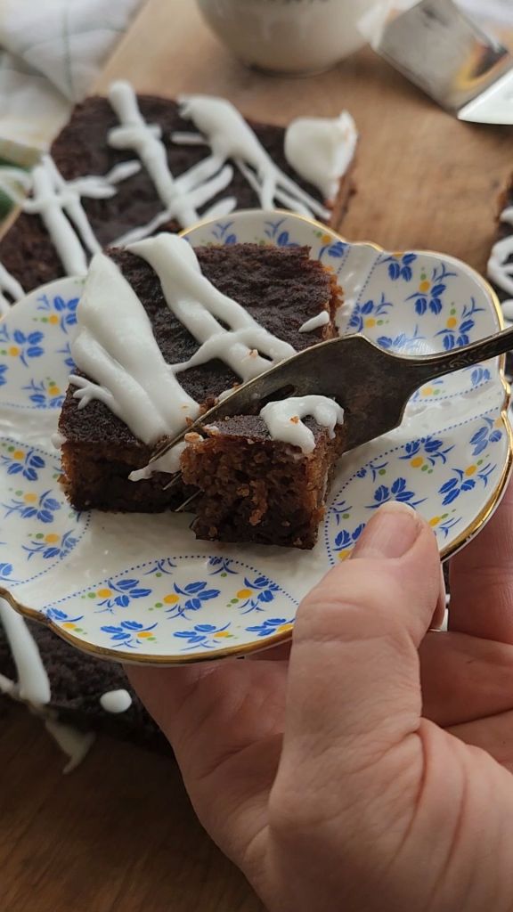 A piece of easy , gluten , free irish spice cake on a plate with a fork