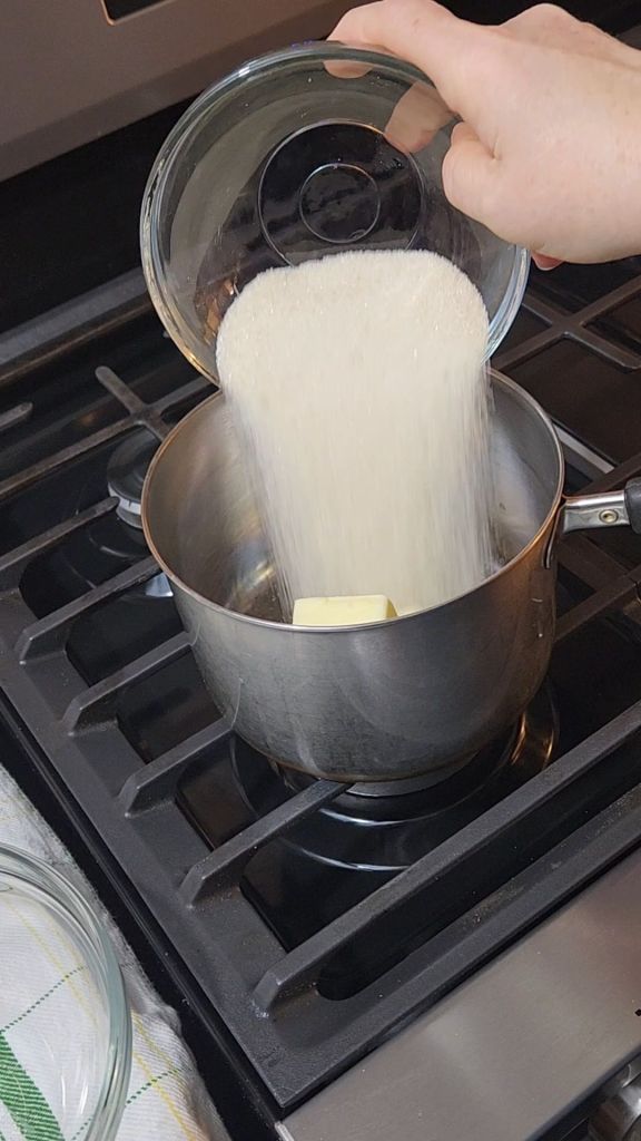 Pouring sweetener into a saucepan with butter