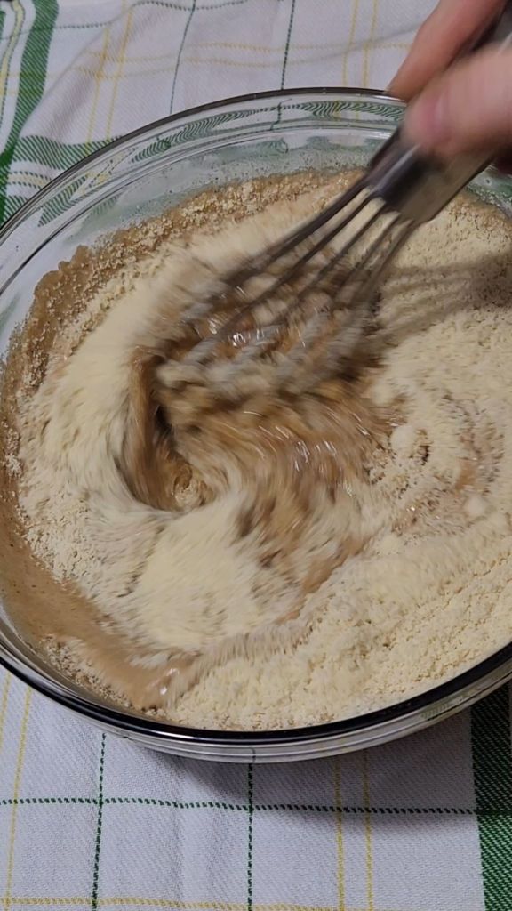Whisking dry ingredients into batter for easy gluten , free irish spice cake