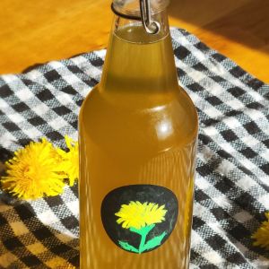 Dandelion syrup in a glass bottle
