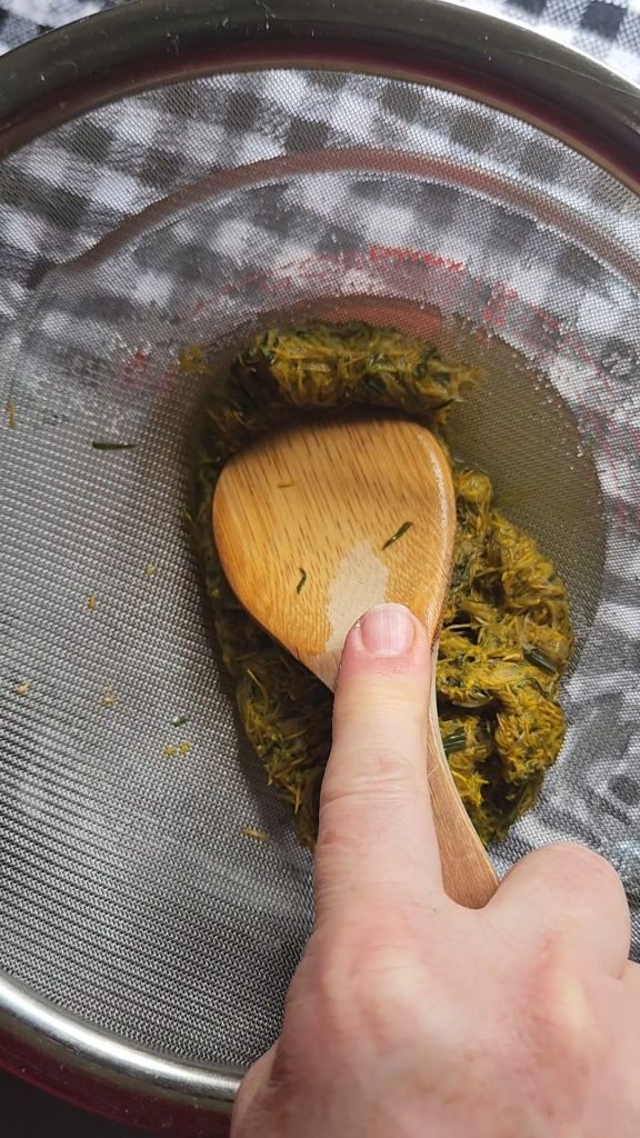Pressing out liquid from dandelion petals